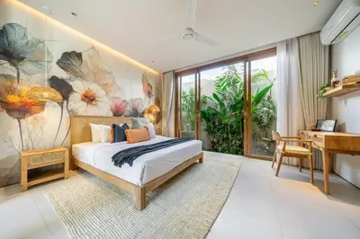 a bedroom with a bed and a desk at Villa Esa Seminyak in Seminyak