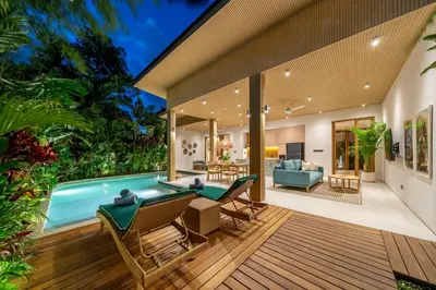 an outdoor living area with a swimming pool in a house at Villa Esa Seminyak in Seminyak