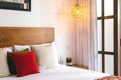 a bedroom with a bed with red and white pillows at Villa Luma in Seminyak