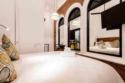 a bedroom with a large white bed with a large mirror at Central 1 Bedroom Villa 5 Min walk to Seminyak Beach in Seminyak