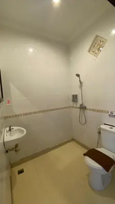 a bathroom with a toilet and a sink at Surya Inn in Kuta