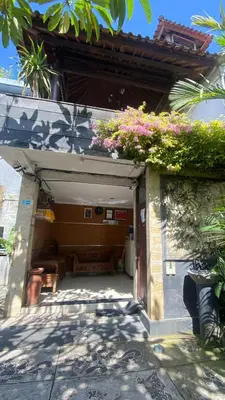 a garage with flowers on the top of it at Surya Inn in Kuta