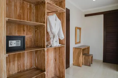 a wooden wall with a tv in a room at White Lotus Villas Seminyak in Seminyak