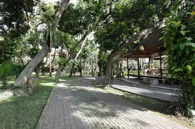 a park with a bench and a gazebo at Matahari Bungalow in Legian