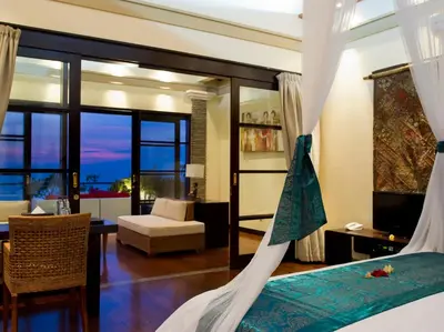 a bedroom with a bed and a living room at Villa LeGa in Seminyak
