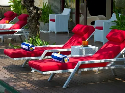 a group of red chairs sitting on a patio at Villa LeGa in Seminyak