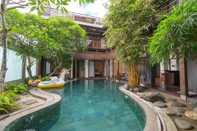 a pool in the middle of a house with trees at Villa Nara - Your Unique & Private Villa in Seminyak Petitenget in Seminyak