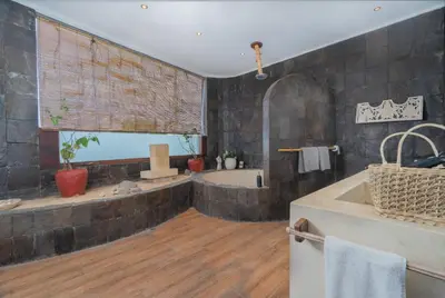 a large bathroom with a tub and a sink at Villa Nara - Your Unique & Private Villa in Seminyak Petitenget in Seminyak