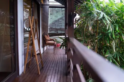a porch with a chair and a ladder on it at Villa Nara - Your Unique & Private Villa in Seminyak Petitenget in Seminyak