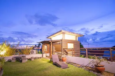 a small wooden house with benches in a yard at Villa Nara - Your Unique & Private Villa in Seminyak Petitenget in Seminyak
