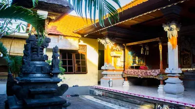 a building with a bench in front of it at Leyeh Leyeh Homestay in Canggu