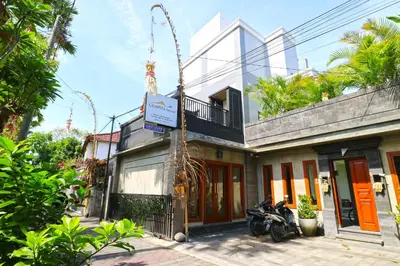 a building with a motorcycle parked in front of it at Gempita House Legian Bali in Legian