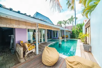 a villa with a swimming pool on a wooden deck at Villa West - Charming 2 bdr villa in Oberoi - PERFECT LOCATION! in Seminyak