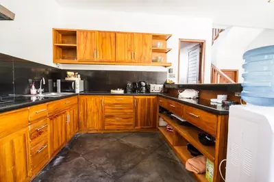 a kitchen with wooden cabinets and black counter tops at Villa Martine - Fantastic 5BR Villa - Perfect Location in Seminyak in Seminyak