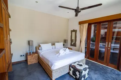 a bedroom with a large bed with white sheets at Villa Martine - Fantastic 5BR Villa - Perfect Location in Seminyak in Seminyak