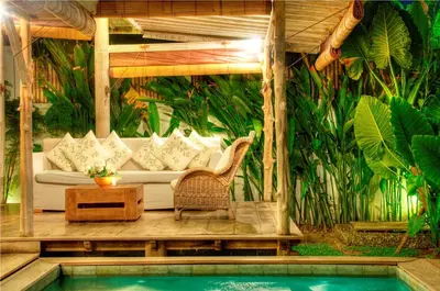 a patio with a couch and a table and a pool at Villa Layla - Charming 2BR Villa in Oberoi - Prime Location! in Seminyak