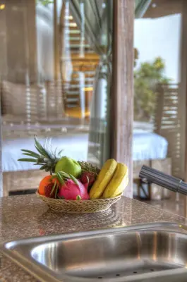 a bowl of fruit on a counter next to a sink at Villa Layla - Charming 2BR Villa in Oberoi - Prime Location! in Seminyak