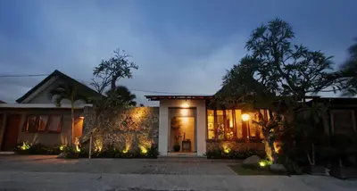 a house with lights on the front of it at Uma Karan in Seminyak