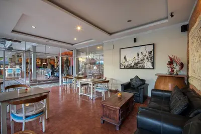 a living room with a couch and chairs and tables at Legian Village Hotel - CHSE Certified in Legian