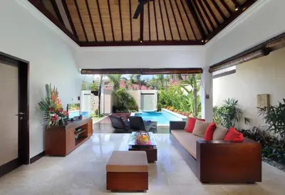 a living room with a couch and a table at RC Villas and Spa Bali in Seminyak
