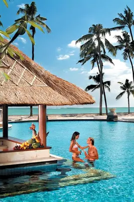 a group of people in the water at a resort at Villas at The Patra Bali Resort and Villas - CHSE Certified in Kuta