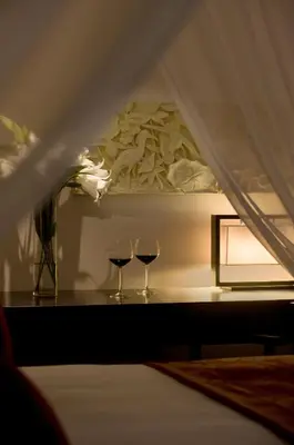 two glasses of wine on a table in a room at Villas at The Patra Bali Resort and Villas - CHSE Certified in Kuta