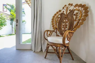 a wooden chair sitting in front of a door at Villa soul in Seminyak