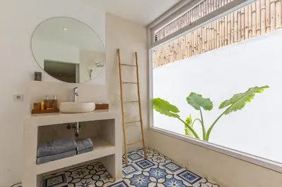 a bathroom with a sink and a window with a mirror at Villa soul in Seminyak