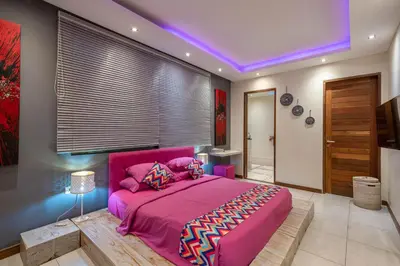 a bedroom with a pink bed with a purple ceiling at Villa Sawah - 3bd in Seminyak Center in Seminyak
