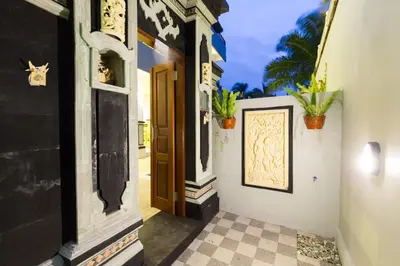 an entrance to a house with a door and plants at Amerta Seminyak in Seminyak