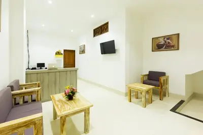 a waiting room with tables and chairs and a counter at Amerta Seminyak in Seminyak