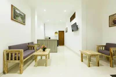 a hospital corridor with chairs and a table at Amerta Seminyak in Seminyak