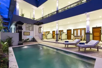 a swimming pool in the middle of a house at Amerta Seminyak in Seminyak