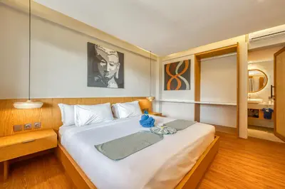 a bedroom with a large white bed in a room at Sejuk Suites in Legian