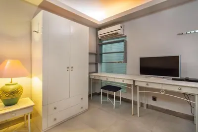 a home office with a desk with a television and a chair at Sejuk Suites in Legian
