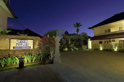 a building with a sign that reads nirut at Nipuri Resort and Villas Seminyak by Kamara in Seminyak