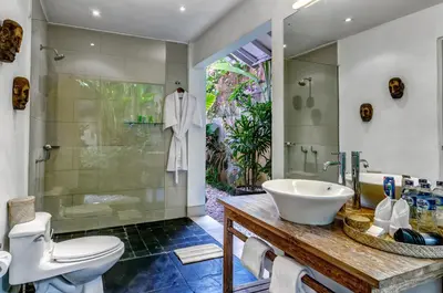a bathroom with a sink and a shower and a toilet at Villa Sipo in Seminyak