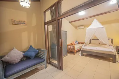 a bedroom with a bed with a mosquito net at Sasa Bali Villas in Seminyak