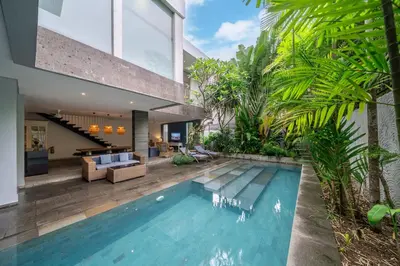 an indoor swimming pool in a villa with a house at Villa Jekumah 2 in Seminyak