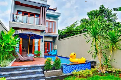 a house with a rubber duck next to a swimming pool at Villa Caitlyn, Seminyak - Modern 3 Bedroom Villa with Private Pool! in Seminyak