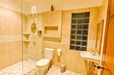 a bathroom with a toilet and a sink and a shower at Villa Caitlyn, Seminyak - Modern 3 Bedroom Villa with Private Pool! in Seminyak