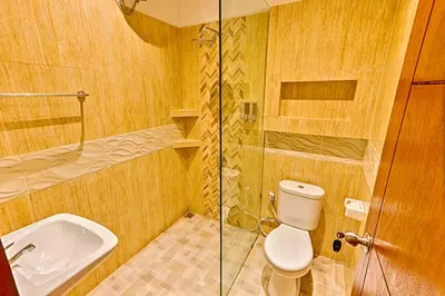 a bathroom with a toilet and a sink and a shower at Villa Caitlyn, Seminyak - Modern 3 Bedroom Villa with Private Pool! in Seminyak