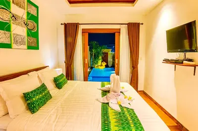 a bedroom with a bed with a stuffed animal on it at Villa Caitlyn, Seminyak - Modern 3 Bedroom Villa with Private Pool! in Seminyak