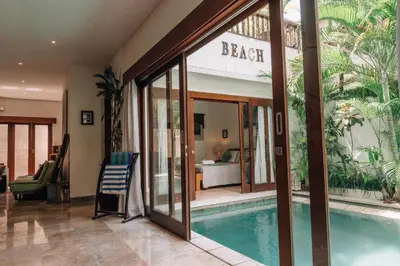 a house with a swimming pool in front of a building at Charming Private Villa with Pool in Canggu