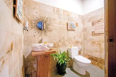 a bathroom with a toilet and a sink at Villa Ellen in Seminyak
