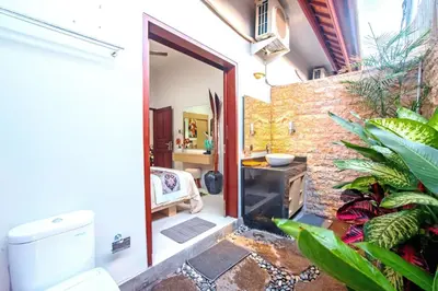 an open door to a bathroom with a sink at Villa Ellen in Seminyak