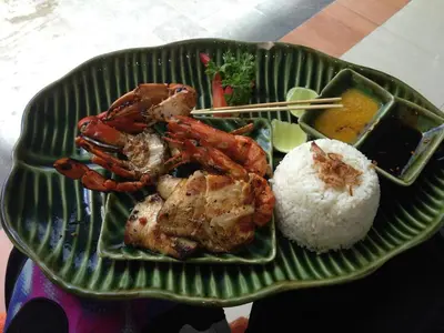 a green plate of food with shrimp and rice at Villa Ellen in Seminyak