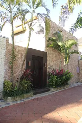 a building with palm trees in front of it at Villa Margaux in Seminyak