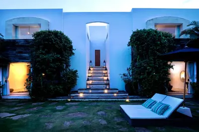 a blue house with a staircase and a couch in the yard at Elegant Villa Casabianca - Tropical Pool & Garden, Near Potato Head Beach Club! in Seminyak