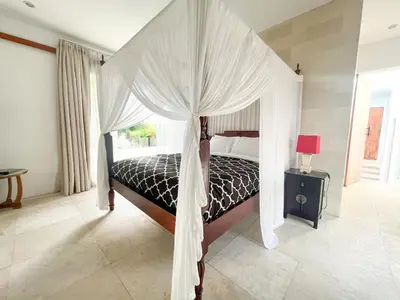 a bedroom with a bed with a canopy at Elegant Villa Casabianca - Tropical Pool & Garden, Near Potato Head Beach Club! in Seminyak